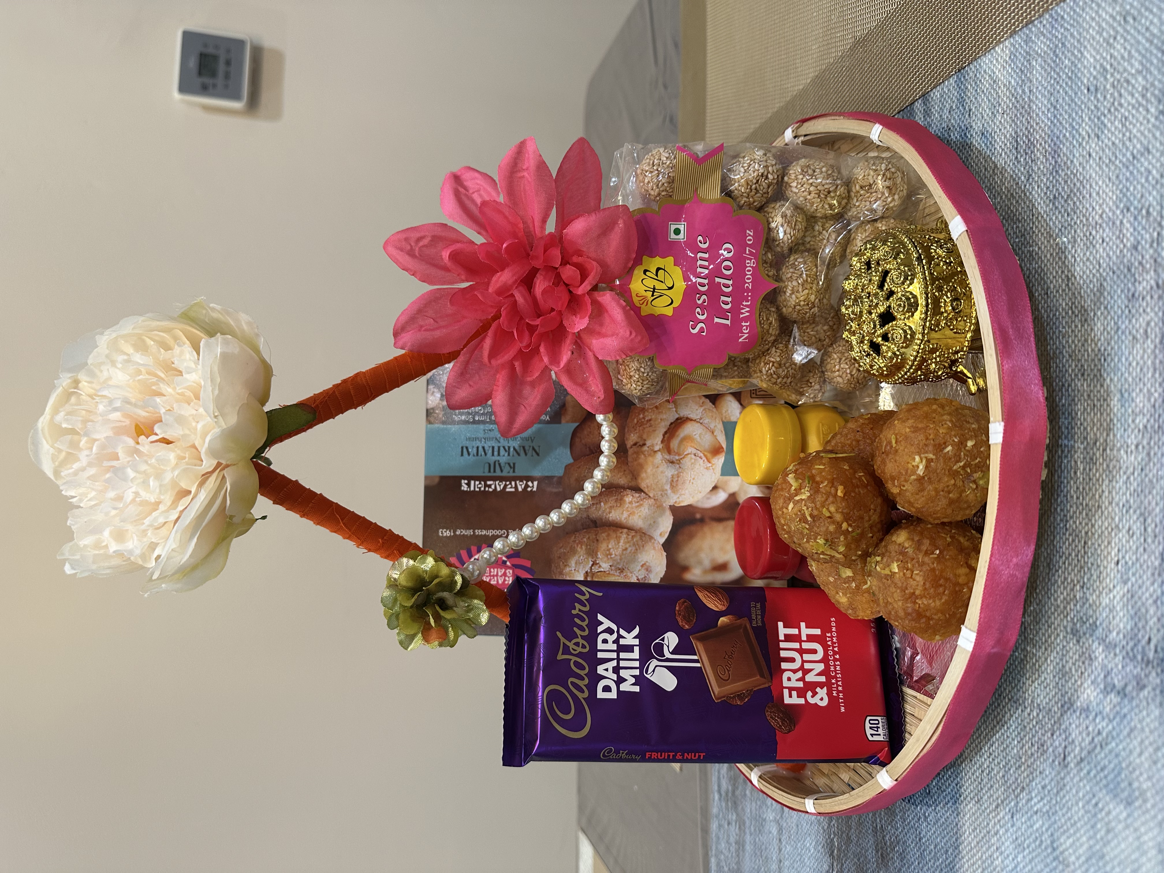 Festival gift basket with sweets, chocolates, and flowers