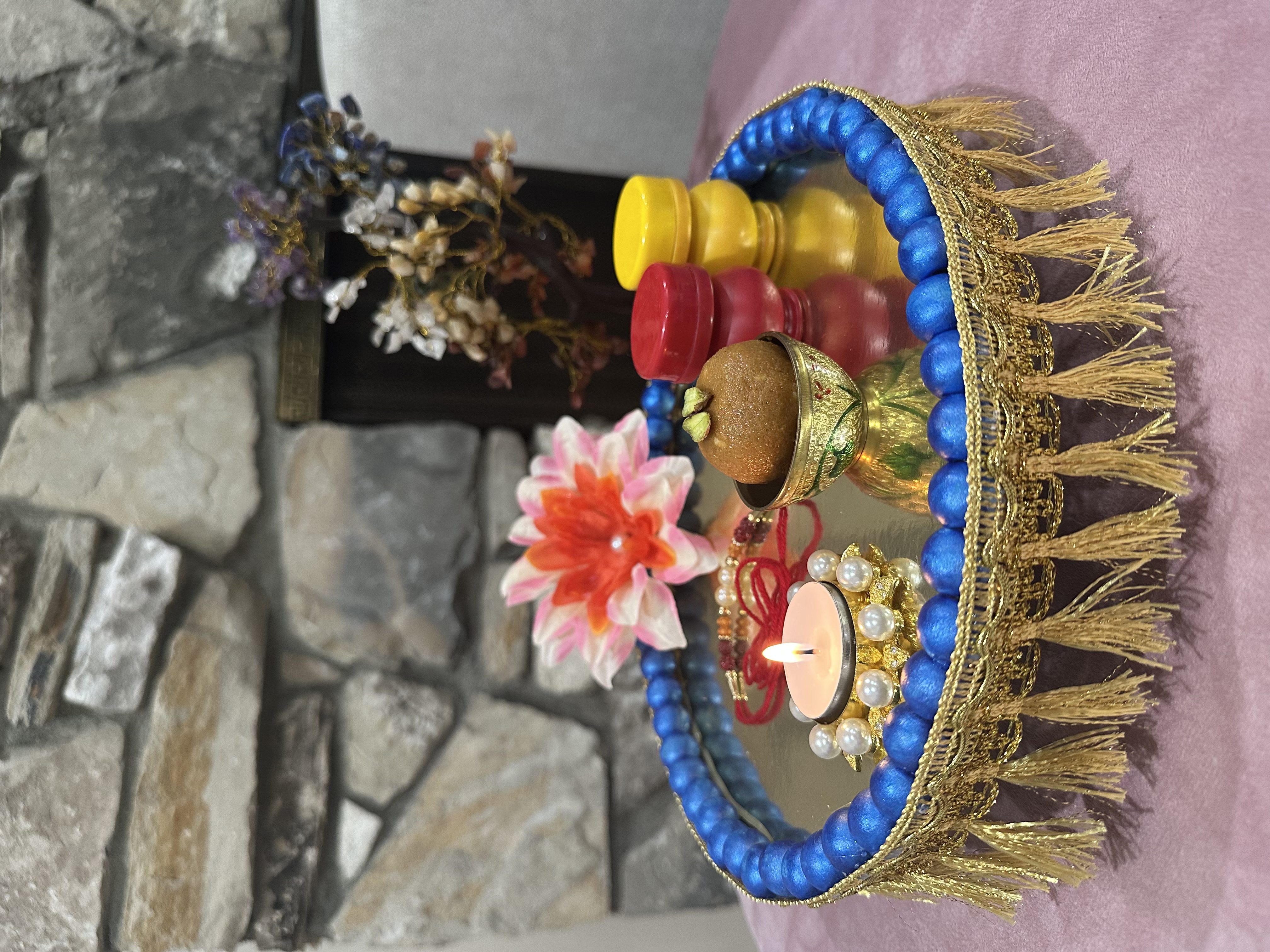 Small festive tray with sweets, a candle, and flowers