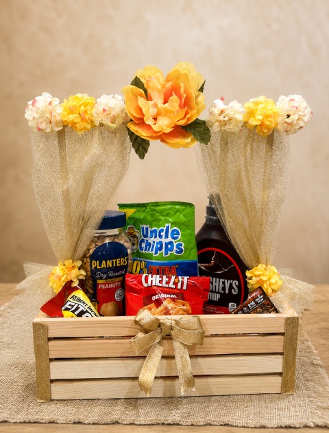Wooden crate gift basket with snacks and flowers